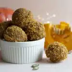 A batch of No-Bake Pumpkin Protein Bites on a rustic table, symbolizing healthy fall snacking.